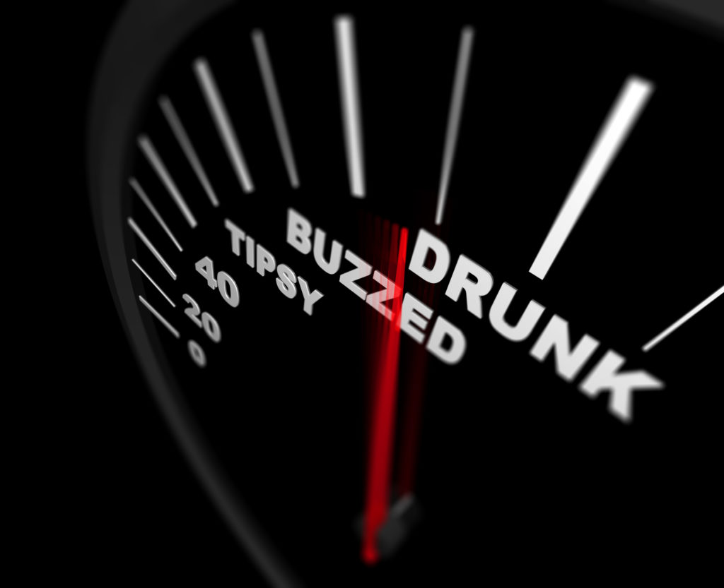 A speedometer in a car showing levels of intoxication instead of numbers