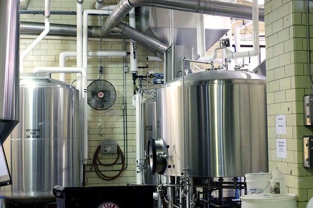A close up of the clean and shining tanks inside a brewery, where beer is professionally and intentionally brewed.
