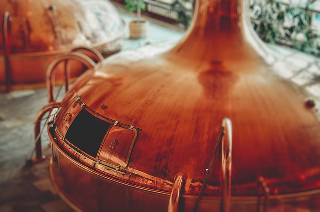 A picture of a copper brewing vessel in a brewery where beer and ale is made.